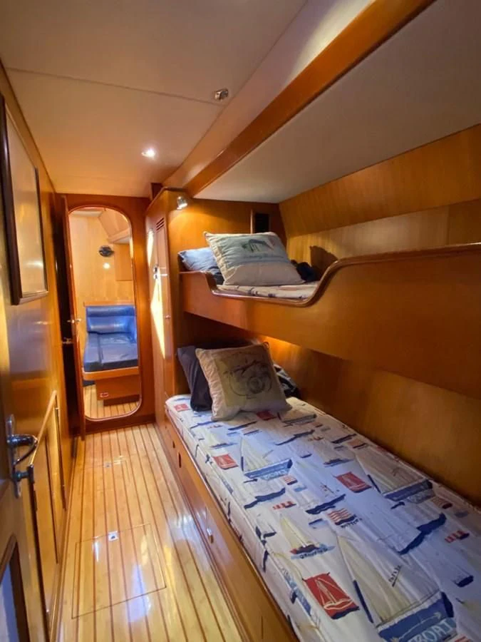 a room with a bed and a mirror aboard EL CACIQUE Yacht for Sale