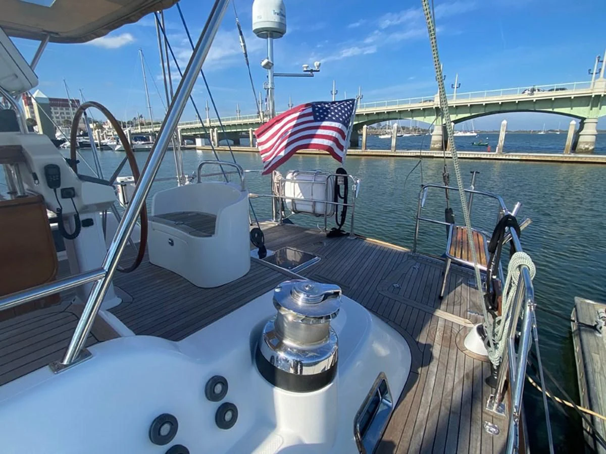 a boat with a flag on the front aboard EL CACIQUE Yacht for Sale