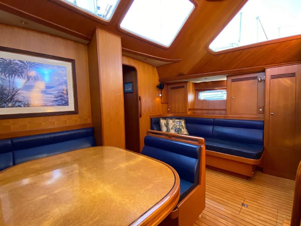 a room with a table and chairs aboard EL CACIQUE Yacht for Sale