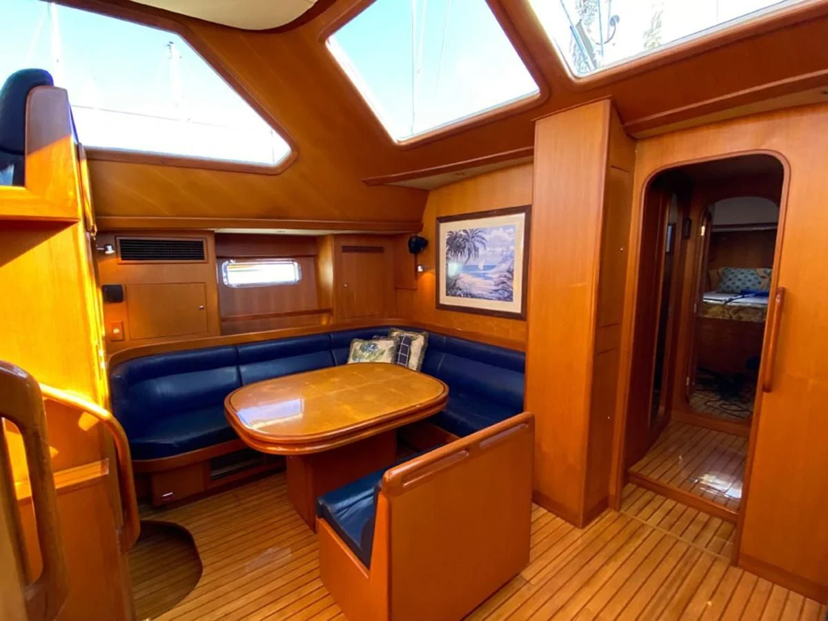 a room with a table and chairs aboard EL CACIQUE Yacht for Sale