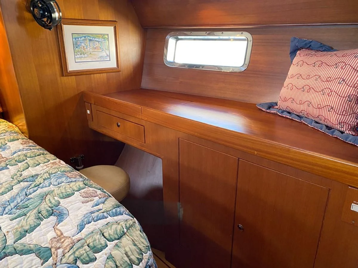a bed and a desk aboard EL CACIQUE Yacht for Sale