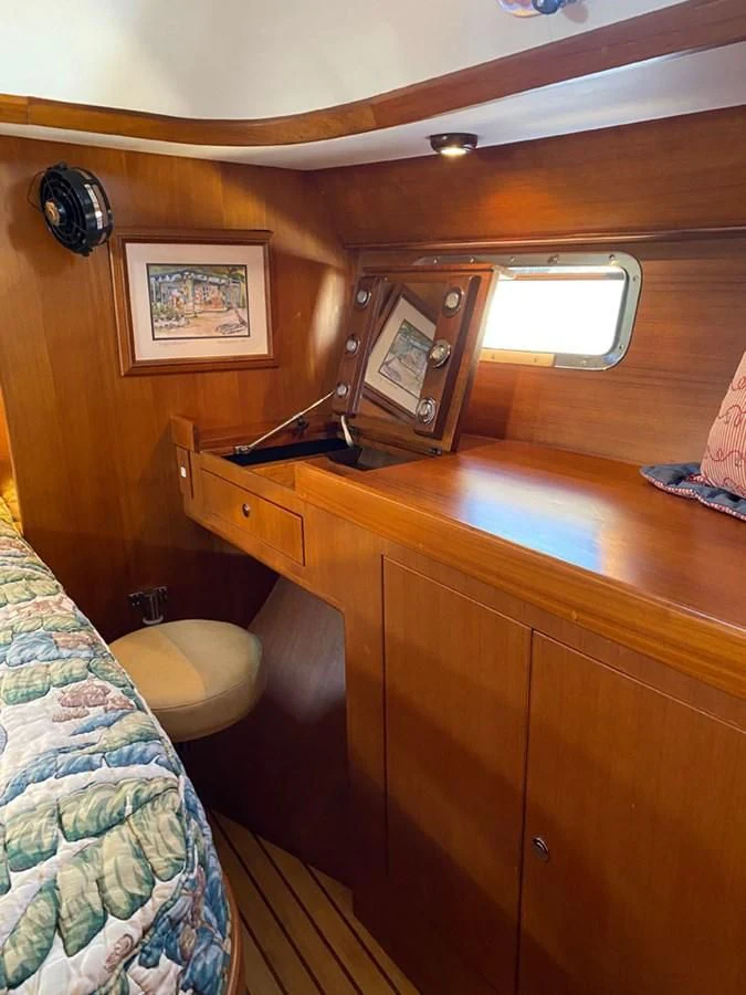 a room with a wood desk and a window aboard EL CACIQUE Yacht for Sale