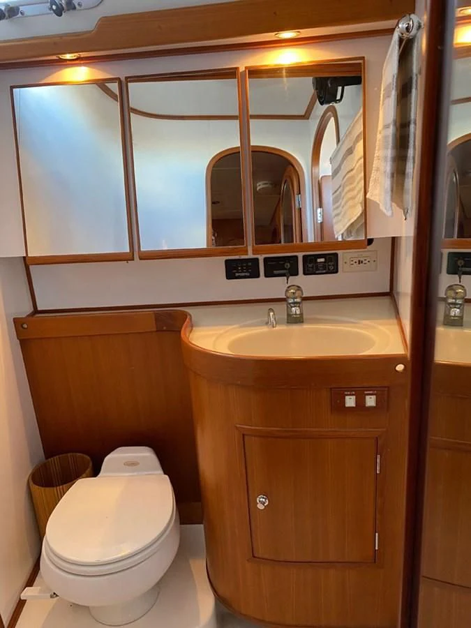 a bathroom with a toilet and a sink aboard EL CACIQUE Yacht for Sale