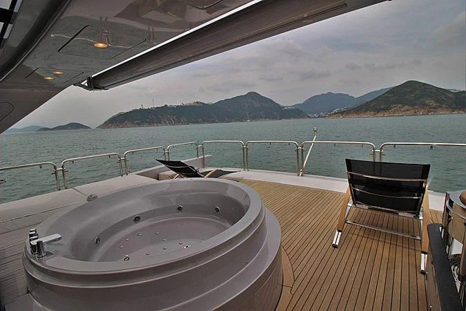 a large white tub on a deck overlooking a body of water aboard G Yacht for Sale