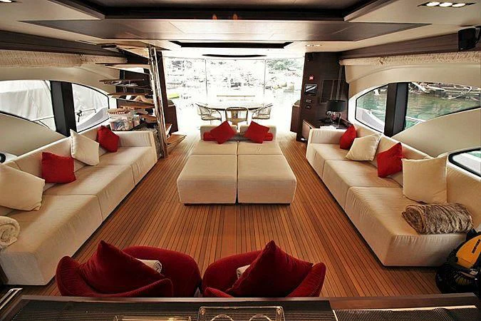 a living room with a couch and a large window aboard G Yacht for Sale