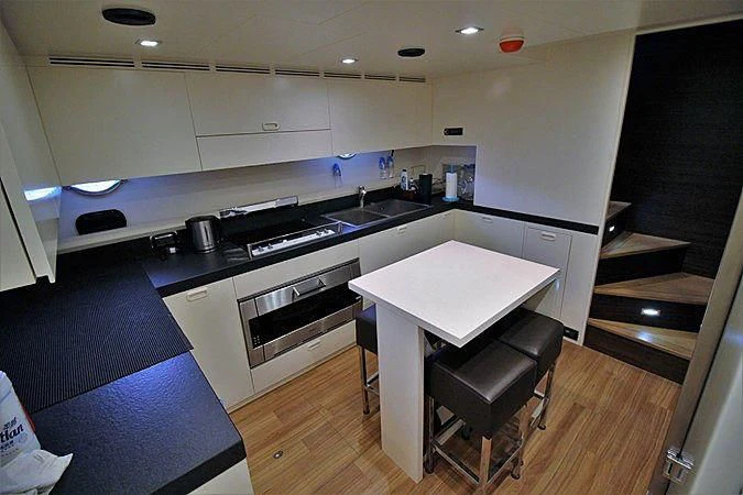 a kitchen with a table and chairs aboard G Yacht for Sale