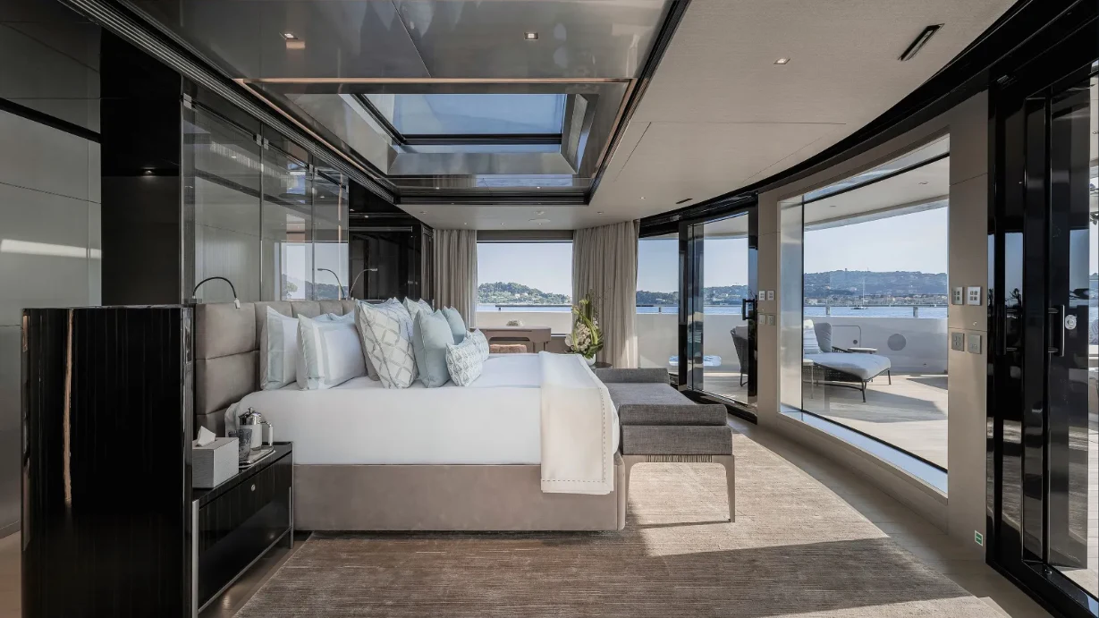 a room with a bed and a large window aboard CLOUD 9 Yacht for Sale