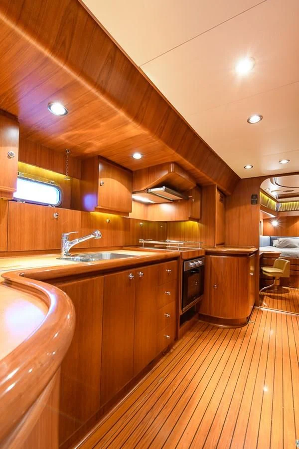 a kitchen with wooden cabinets aboard CRYSTAL Yacht for Sale