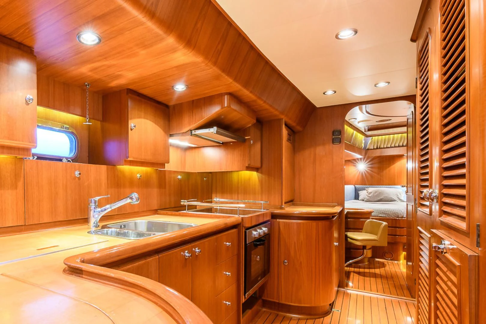 a kitchen with wooden cabinets aboard CRYSTAL Yacht for Sale