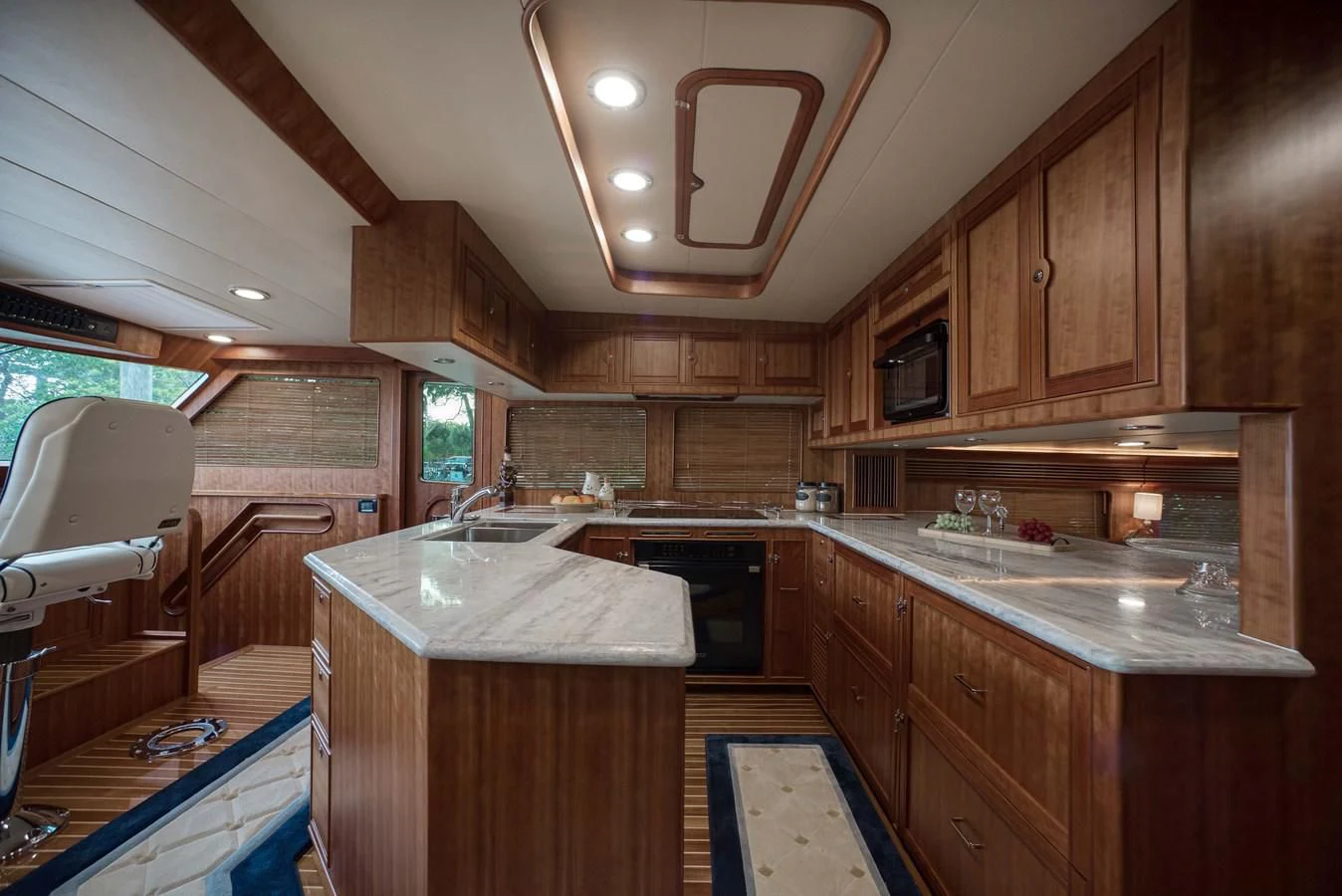 a kitchen with wooden cabinets aboard MAGIC Yacht for Sale