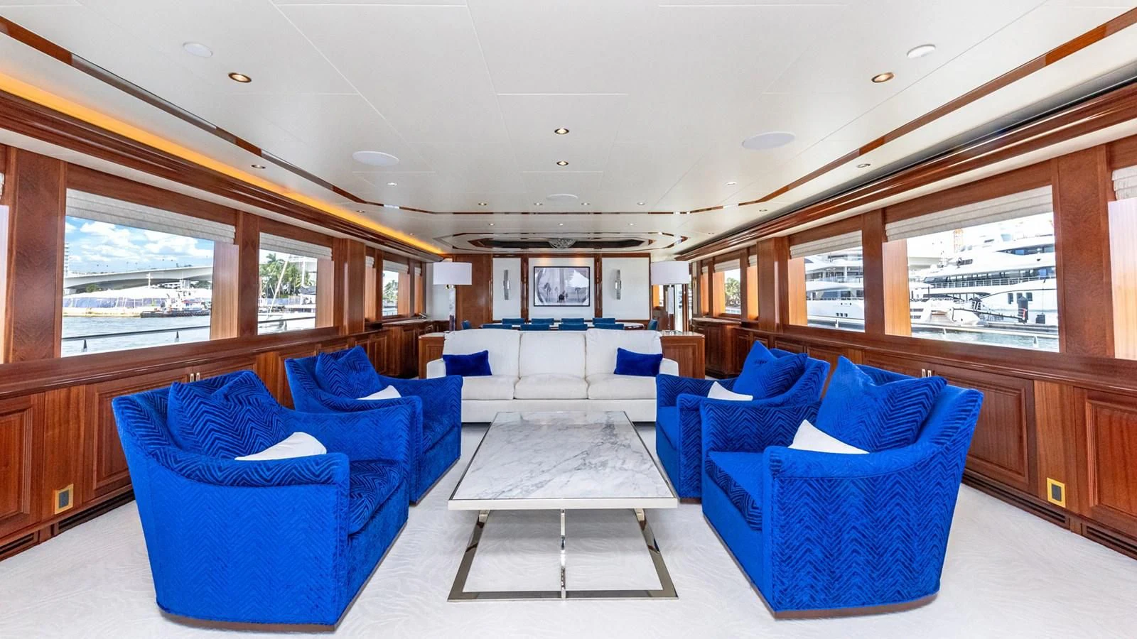 a room with blue chairs and a table aboard BLUE TIME Yacht for Sale