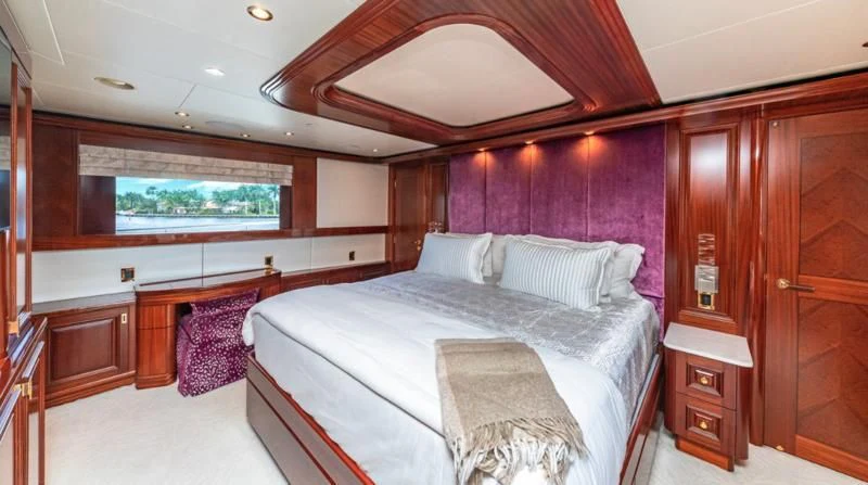 a room with a bed and a window aboard BLUE TIME Yacht for Sale