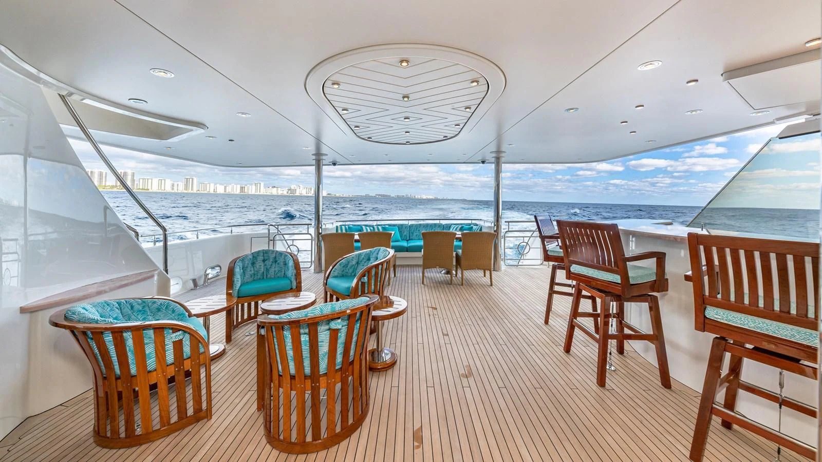 a deck with chairs and tables on it aboard BLUE TIME Yacht for Sale