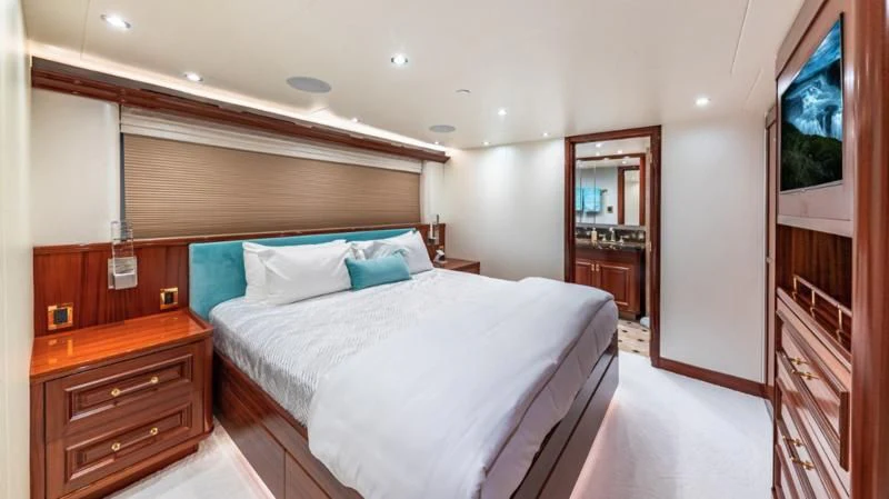 a bedroom with a bed and a television aboard BLUE TIME Yacht for Sale