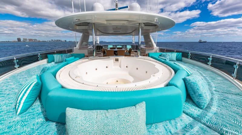 a large white pool with a round white round table and chairs on a boat with water and blue aboard BLUE TIME Yacht for Sale