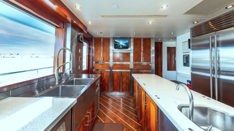 a kitchen with a countertop sink and a large window aboard BLUE TIME Yacht for Sale