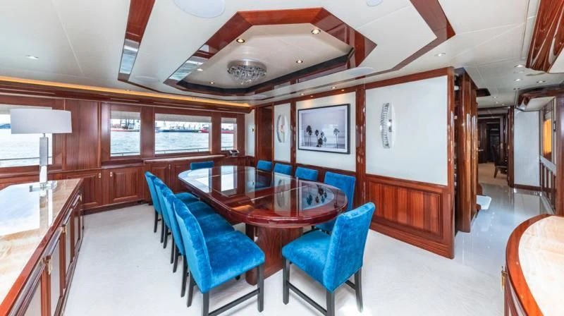 a room with a table chairs and a window aboard BLUE TIME Yacht for Sale