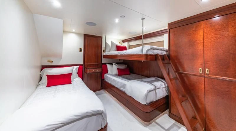 a room with a bed and a closet aboard BLUE TIME Yacht for Sale