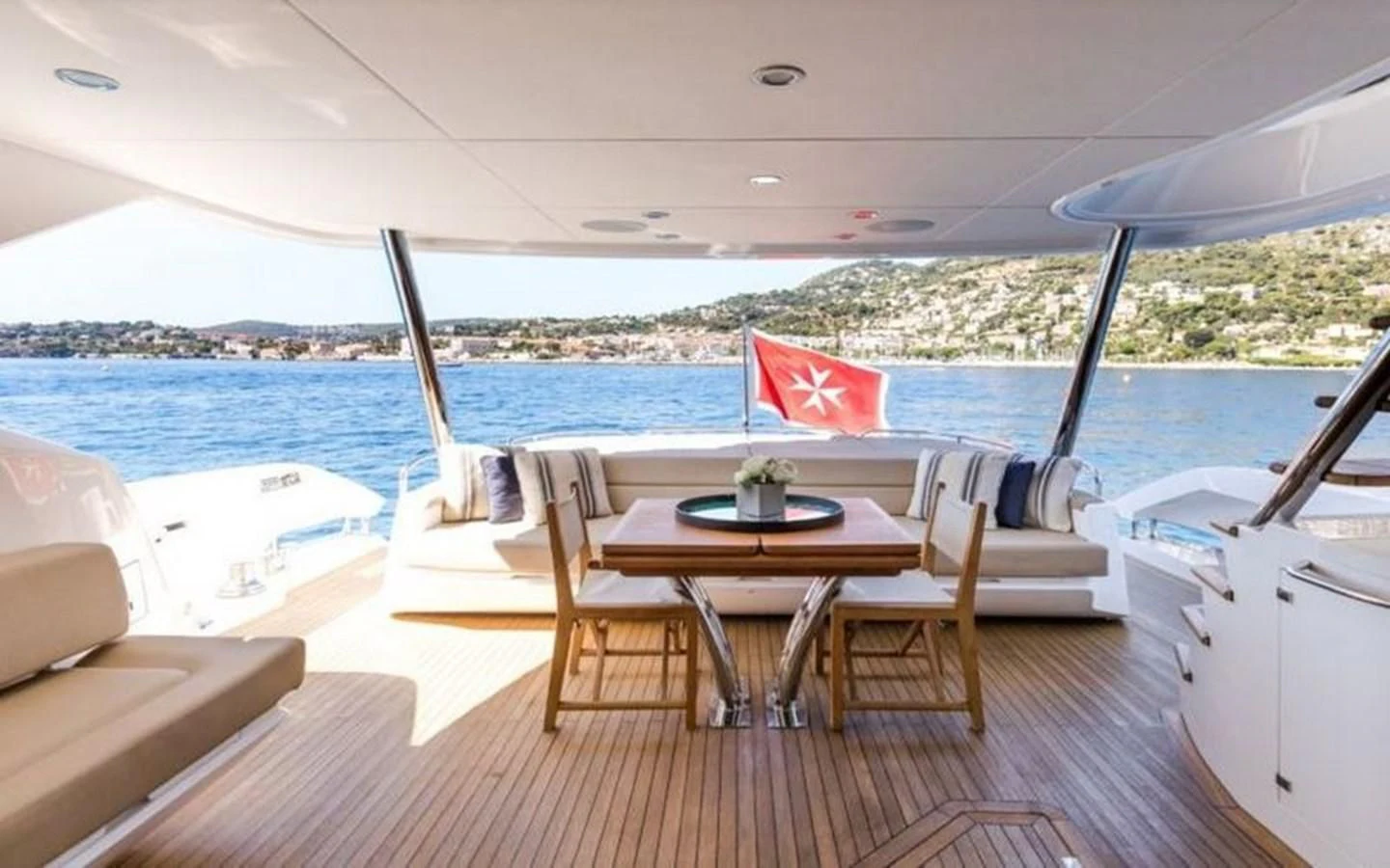 a table and chairs on a deck aboard YINWA Yacht for Sale