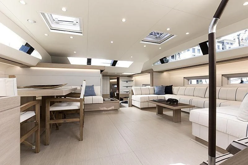 a room with white couches and a table aboard KIBOKO TRES Yacht for Sale