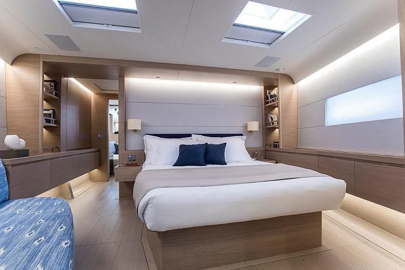 a large bedroom with a large bed aboard KIBOKO TRES Yacht for Sale