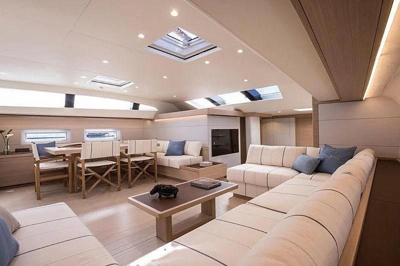 a living room with a couch and a table aboard KIBOKO TRES Yacht for Sale