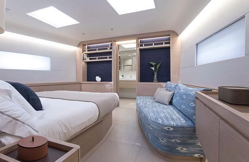 a bedroom with a bed and a desk aboard KIBOKO TRES Yacht for Sale
