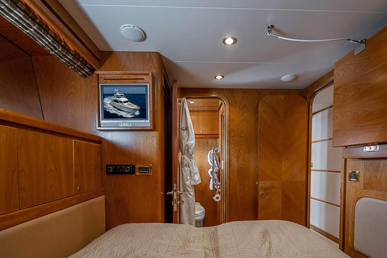 a bedroom with a bed and a closet aboard ROXY MARIA Yacht for Sale