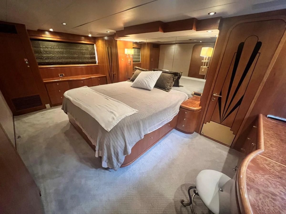 a bedroom with a bed and a wood door aboard ROXY MARIA Yacht for Sale