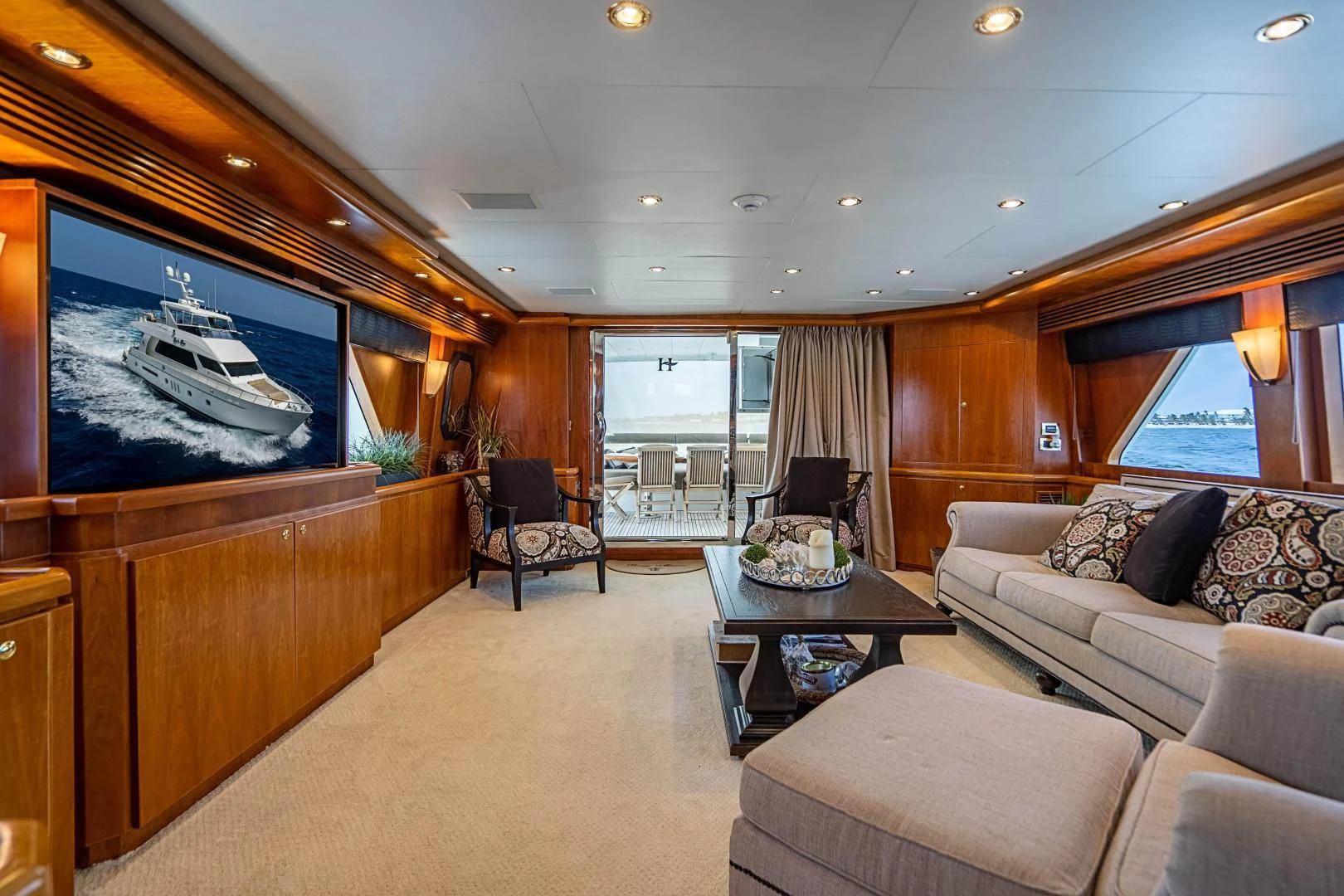a living room with a large screen aboard ROXY MARIA Yacht for Sale