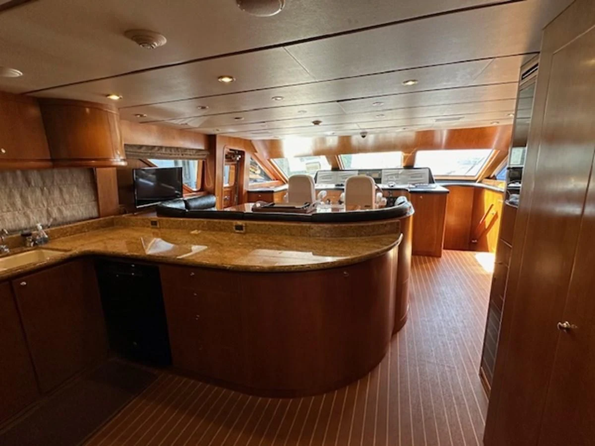 a large kitchen with a bar and a large island aboard ROXY MARIA Yacht for Sale