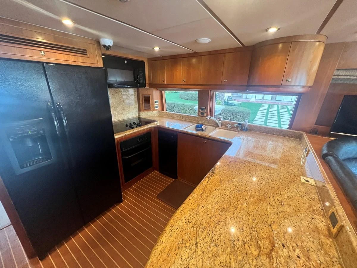 a large kitchen with black cabinets aboard ROXY MARIA Yacht for Sale