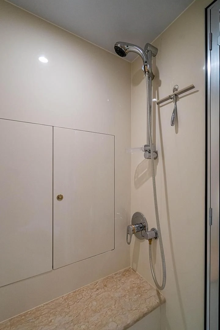 a shower with a white wall aboard ROXY MARIA Yacht for Sale