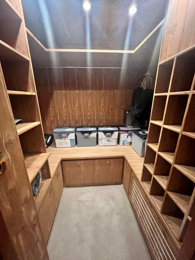a room with a wood floor and shelves and a shelf with objects on it aboard ROXY MARIA Yacht for Sale