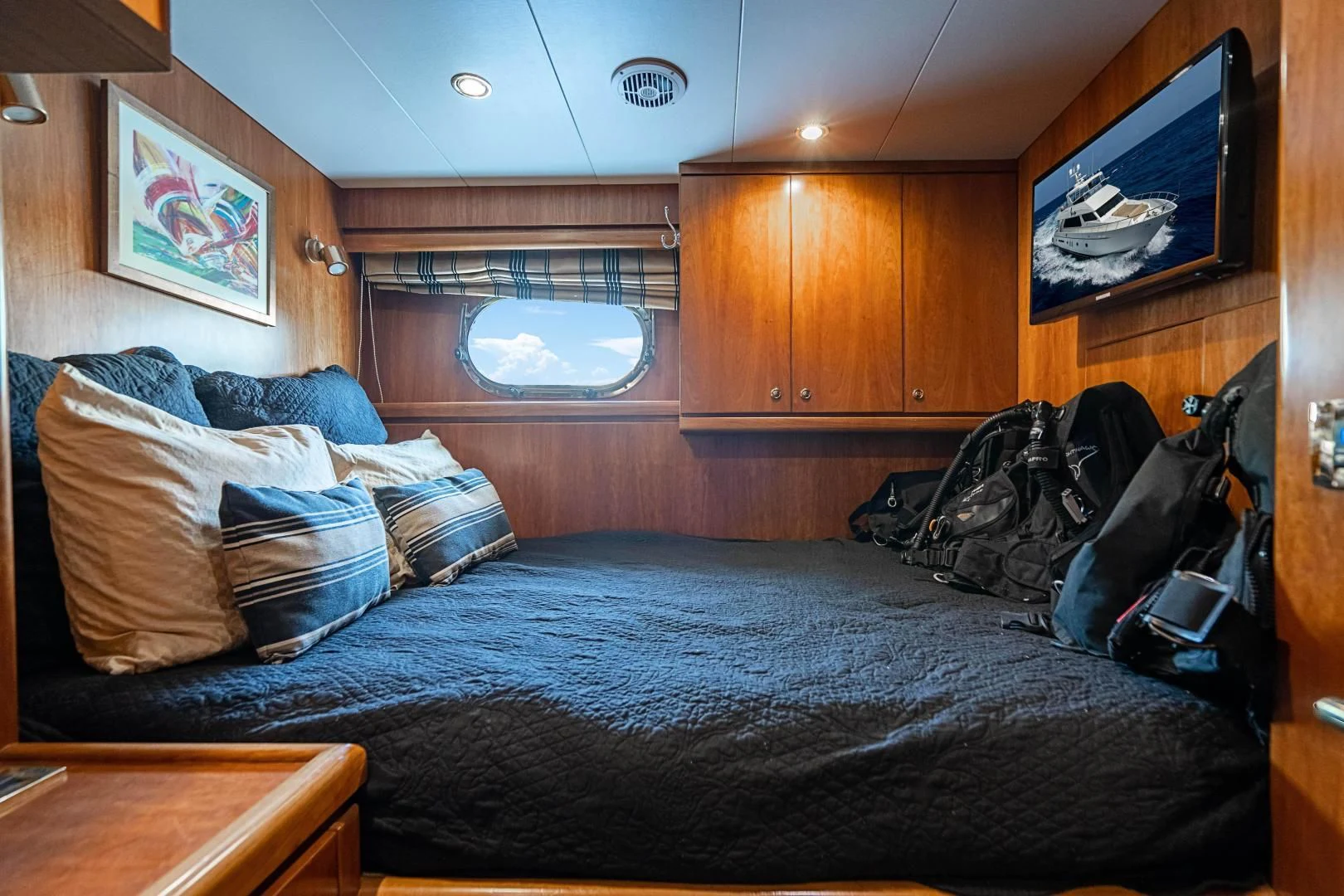 a bed with a blue comforter aboard ROXY MARIA Yacht for Sale