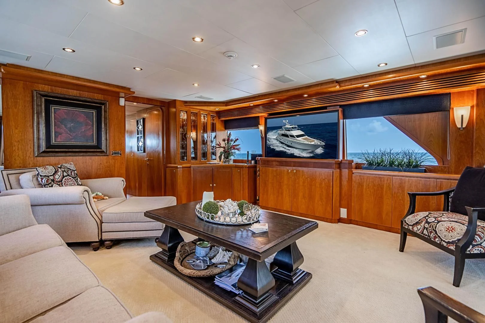 a living room with a large glass coffee table and a large window aboard ROXY MARIA Yacht for Sale