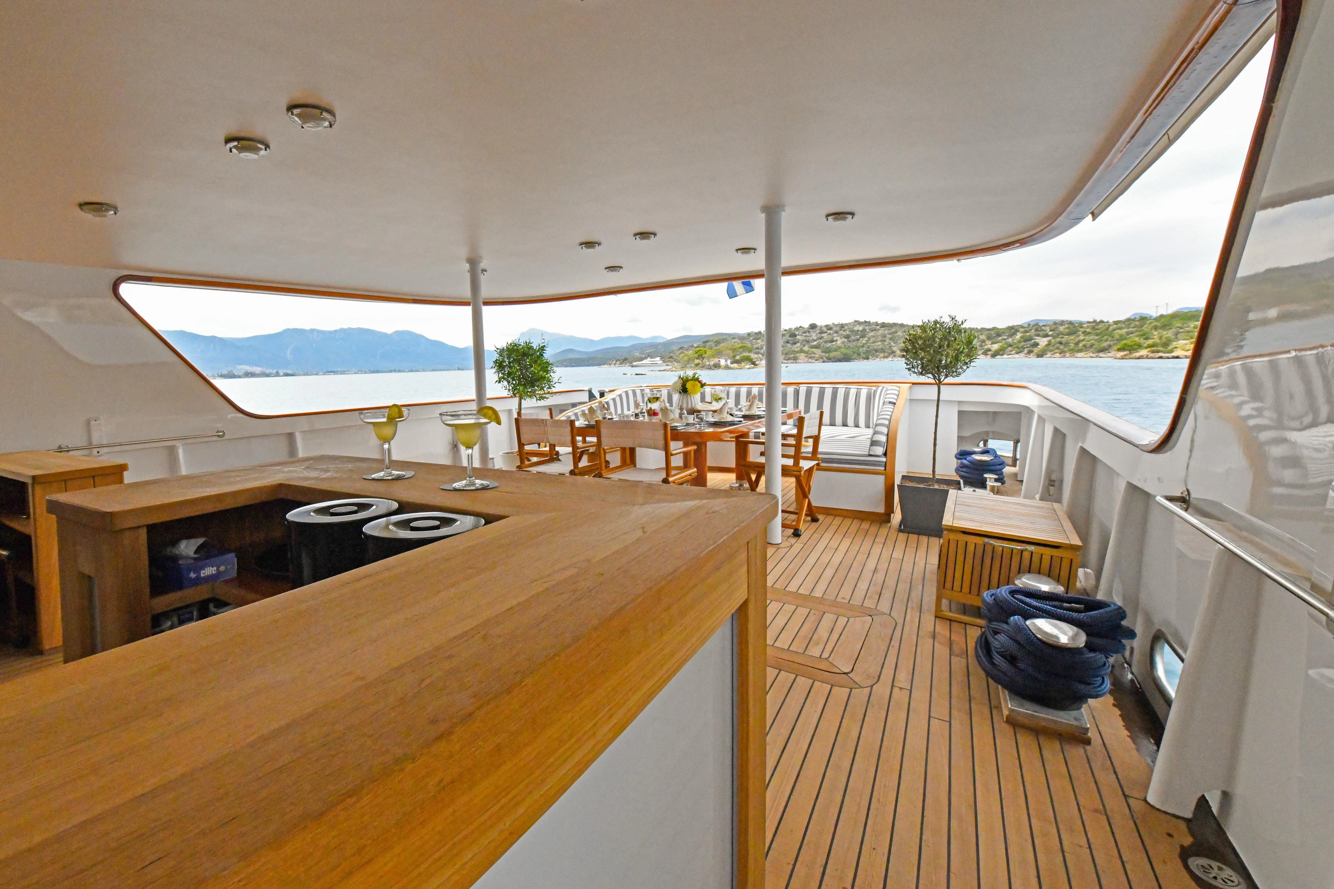 a room with a table and chairs aboard SOMETHING COOL Yacht for Charter
