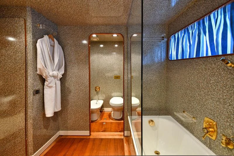 a bathroom with a bathtub and toilet aboard SOMETHING COOL Yacht for Charter