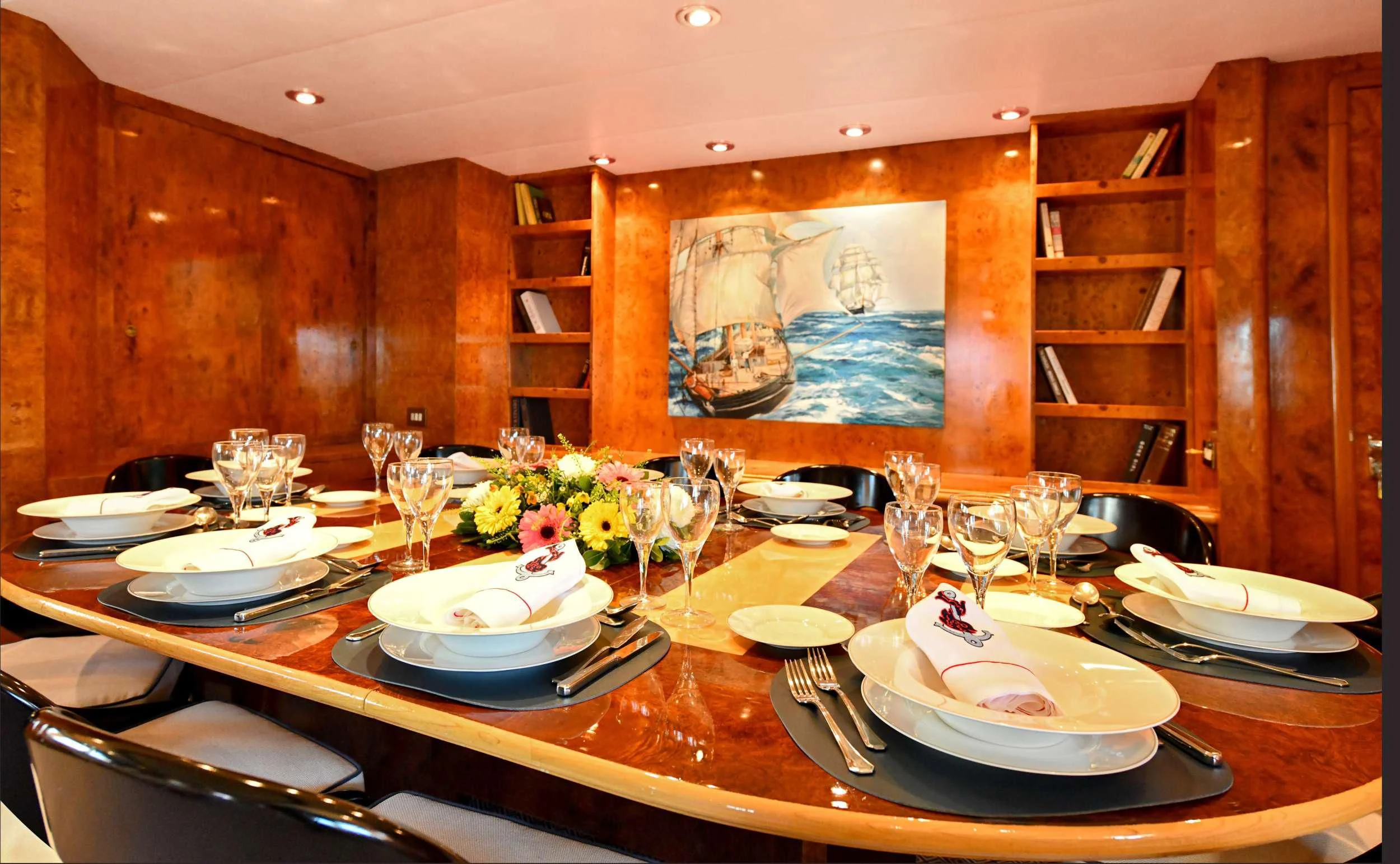 a table with plates and glasses aboard SOMETHING COOL Yacht for Charter