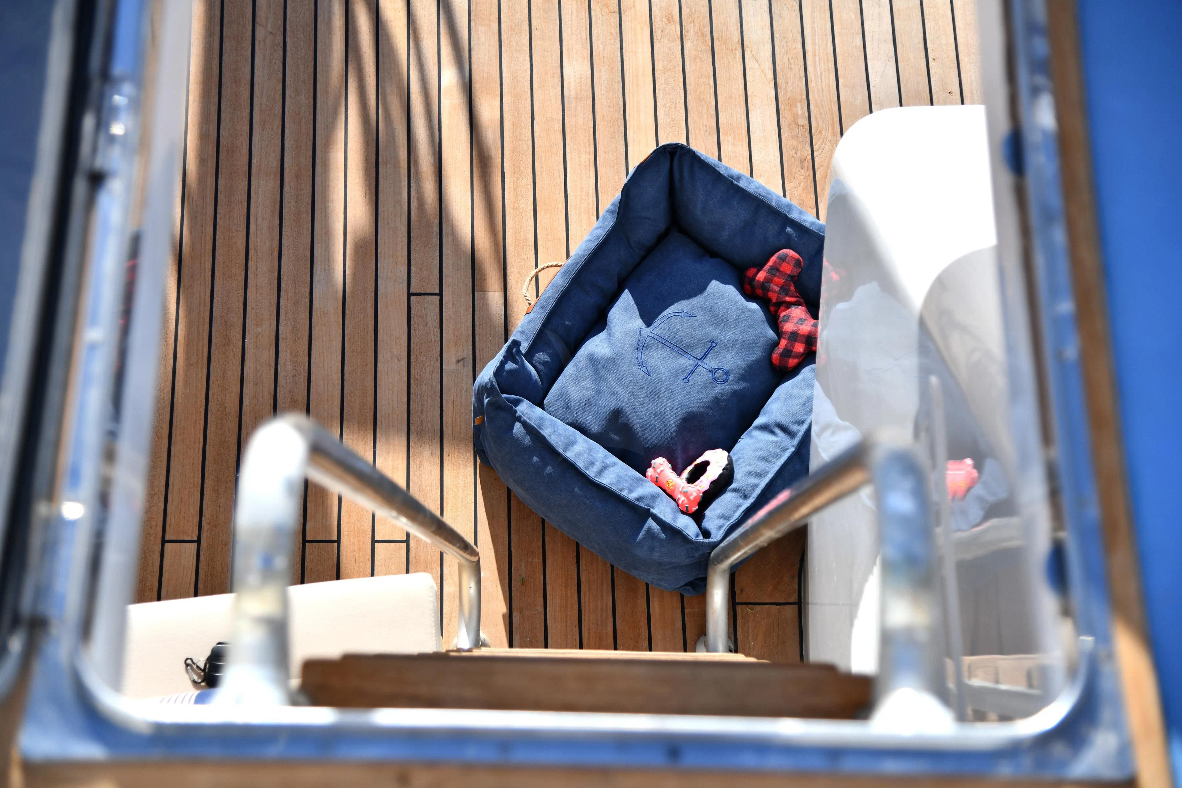 a blue bag on a chair aboard SOMETHING COOL Yacht for Charter