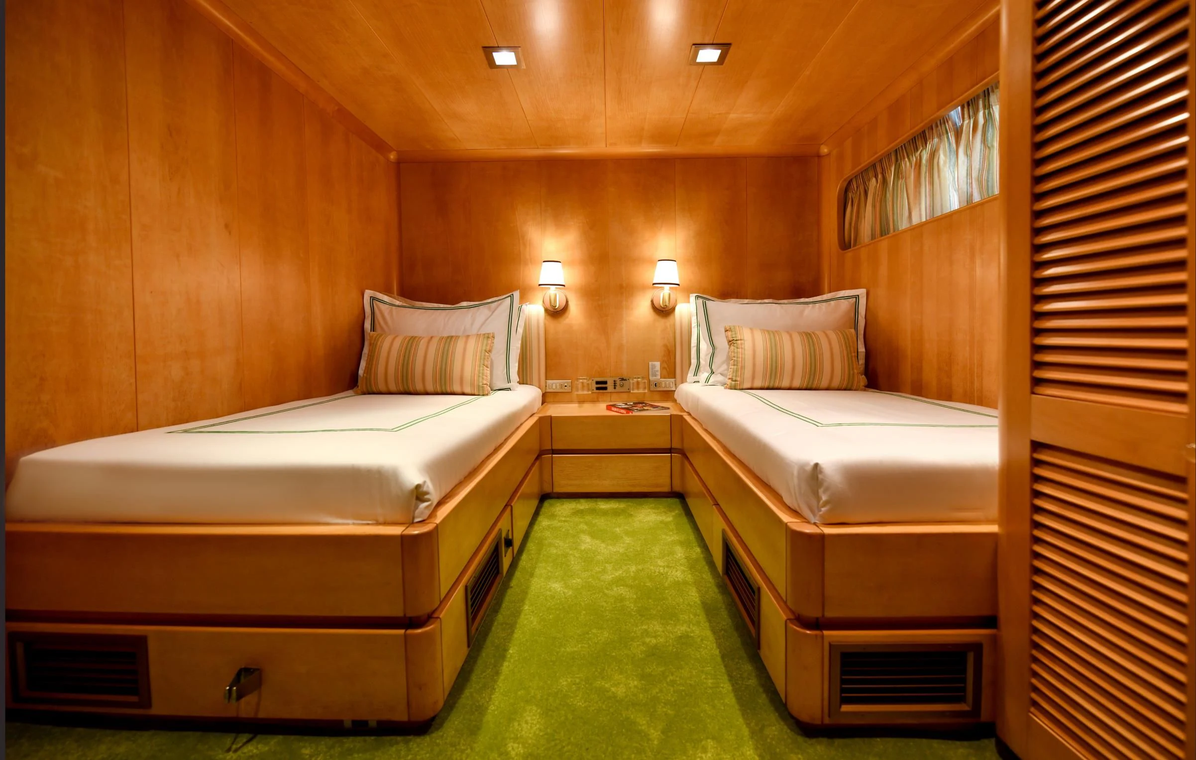 a room with a couple of beds aboard SOMETHING COOL Yacht for Charter
