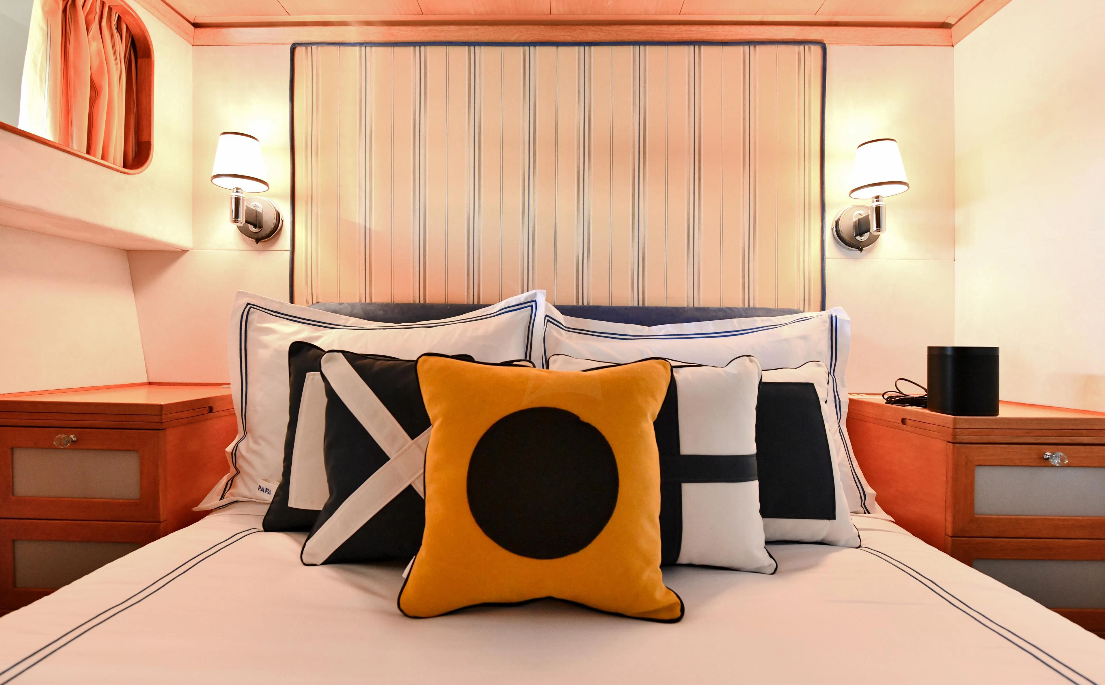 a bed with pillows and a pillow aboard SOMETHING COOL Yacht for Charter