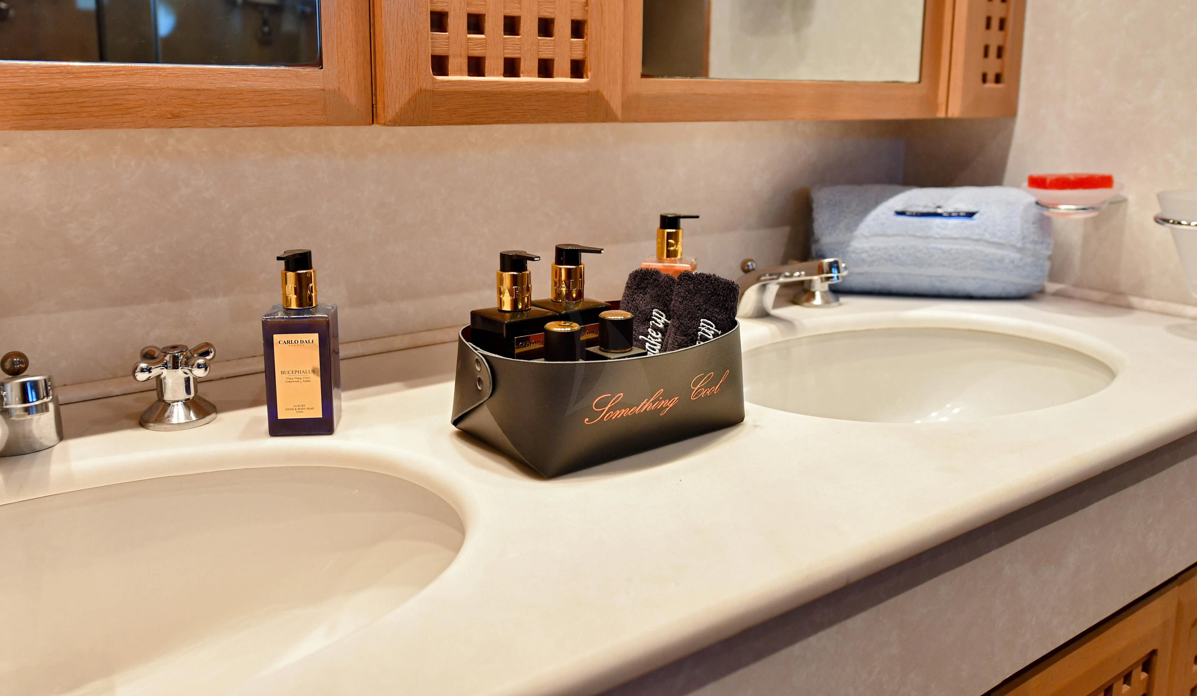 a bathroom sink with a box of tissues on it aboard SOMETHING COOL Yacht for Charter