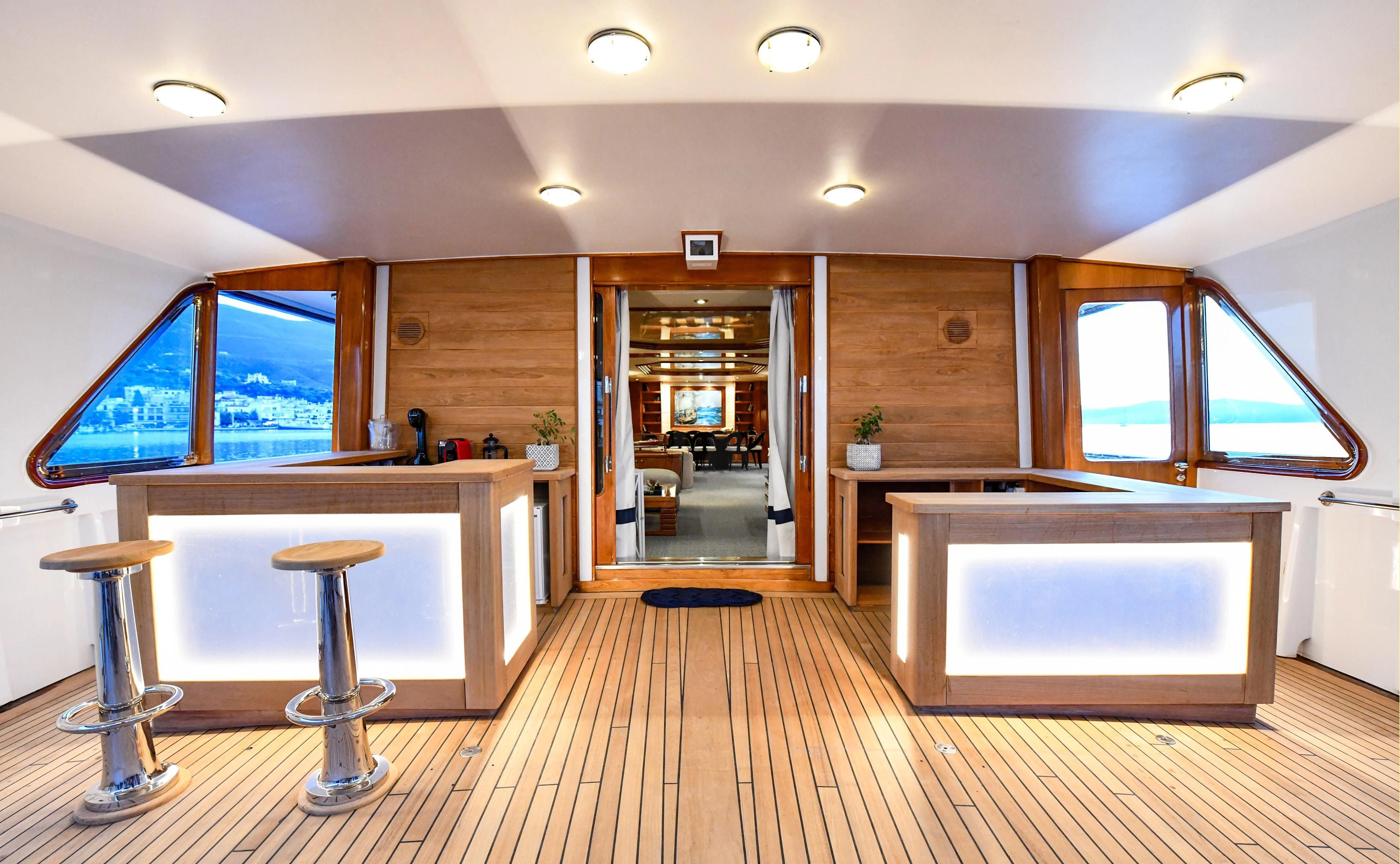 a kitchen with a bar and stools aboard SOMETHING COOL Yacht for Charter