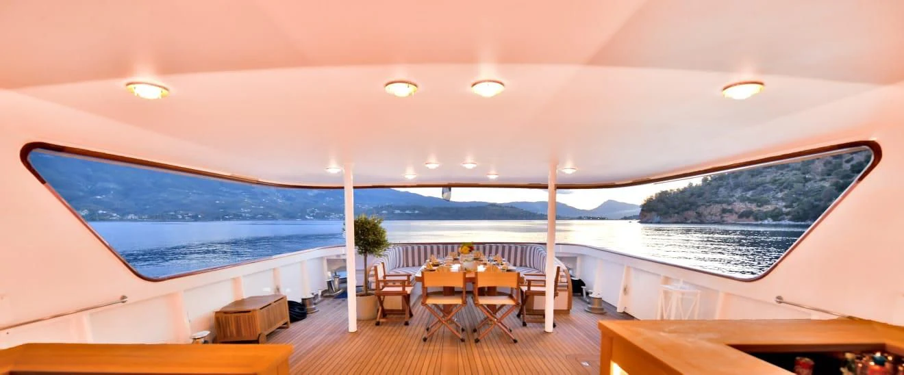 a room with a table and chairs aboard SOMETHING COOL Yacht for Charter