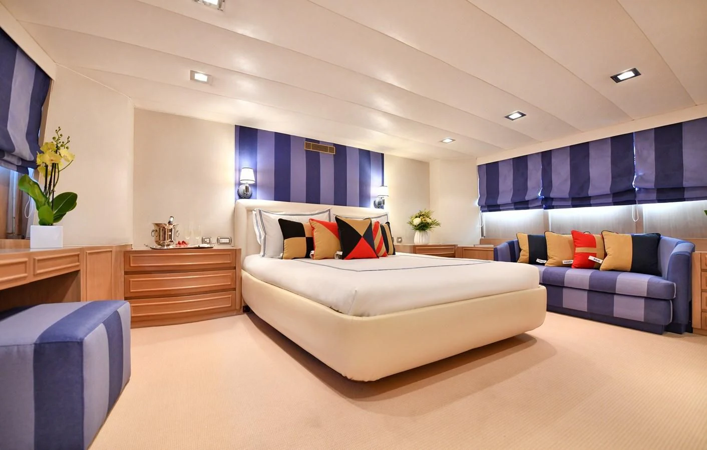 a large room with a couch and a television aboard SOMETHING COOL Yacht for Charter