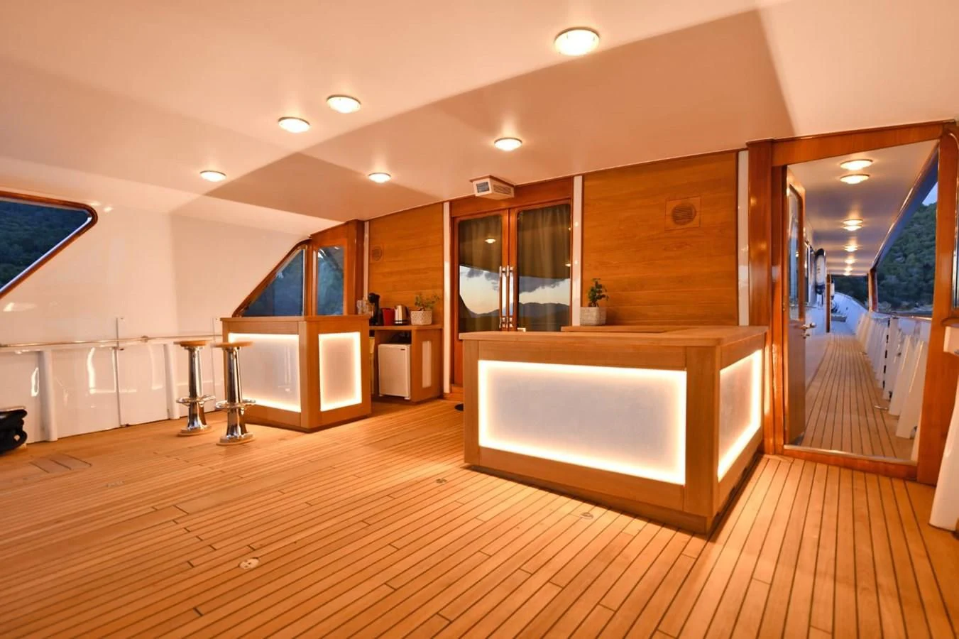 a large room with a wood floor and a large mirror aboard SOMETHING COOL Yacht for Charter
