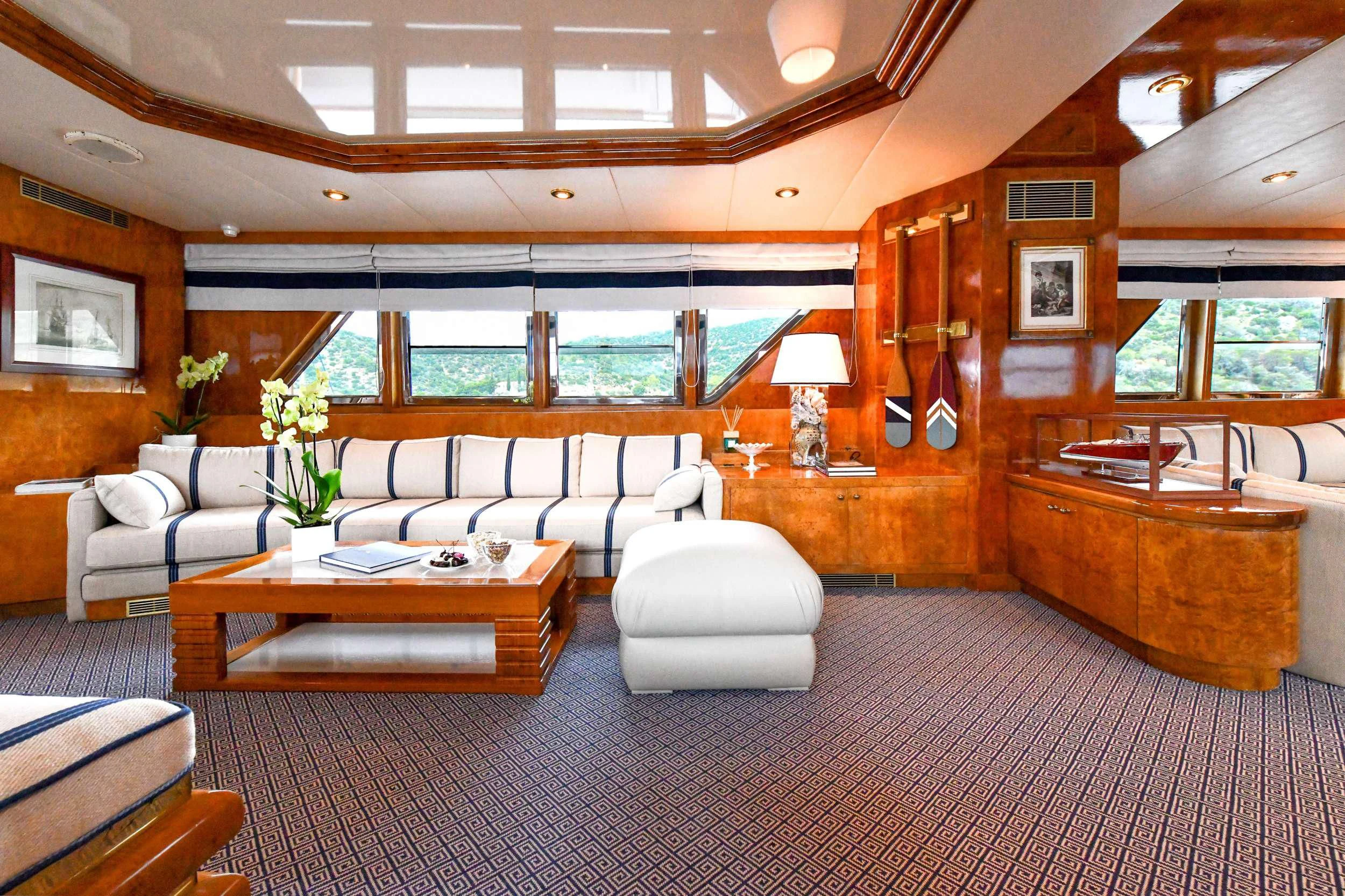 a living room with a large window aboard SOMETHING COOL Yacht for Charter