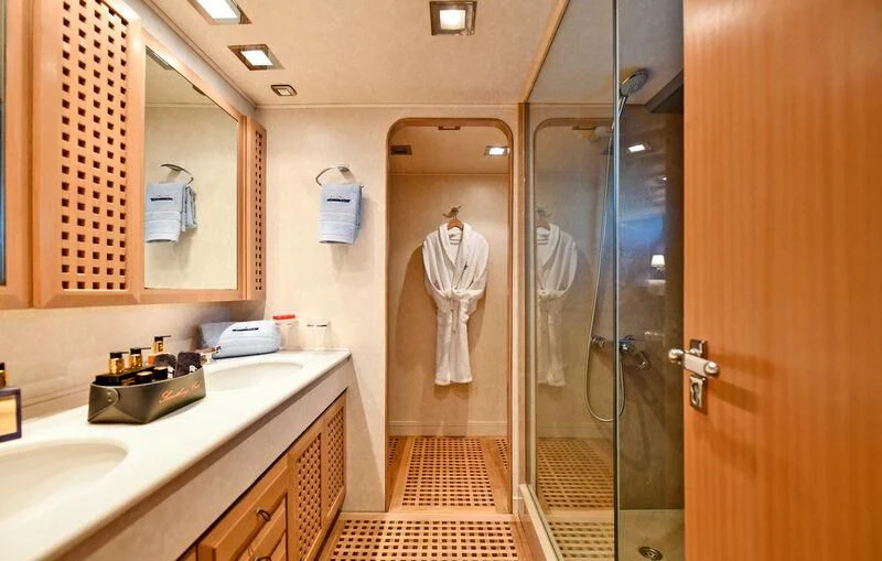 a bathroom with a glass shower aboard SOMETHING COOL Yacht for Charter