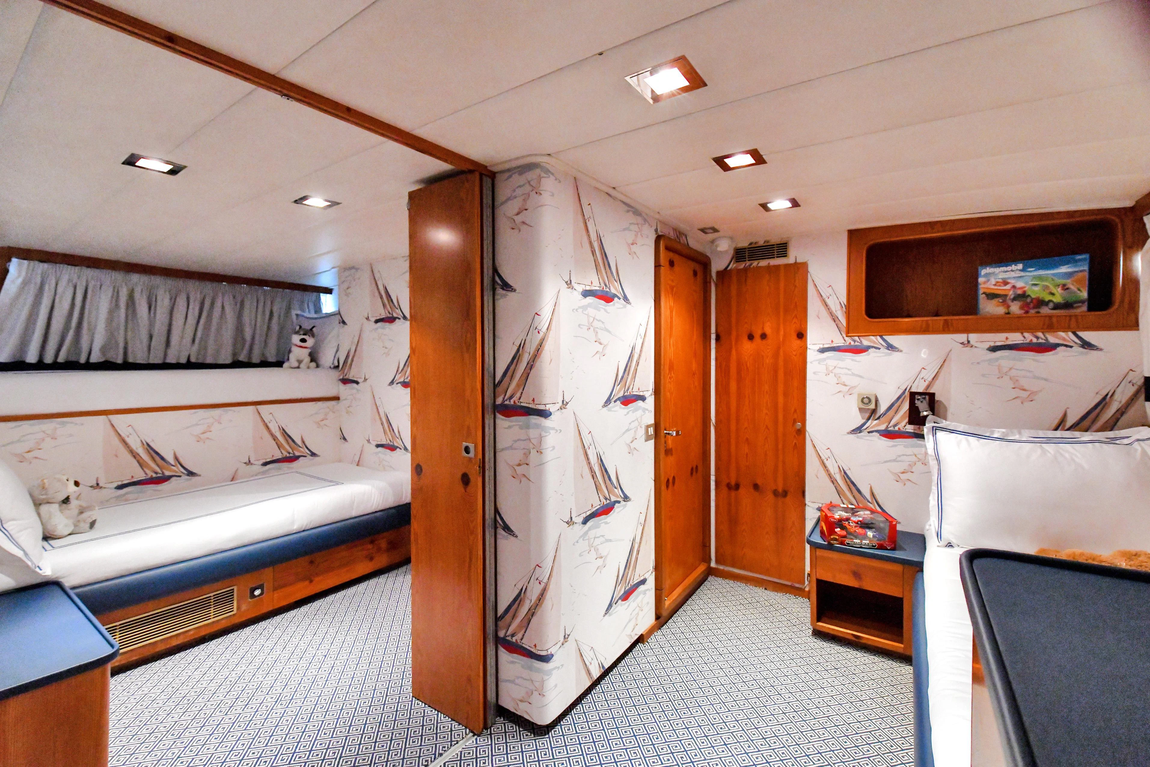 a room with a bed and a desk aboard SOMETHING COOL Yacht for Charter
